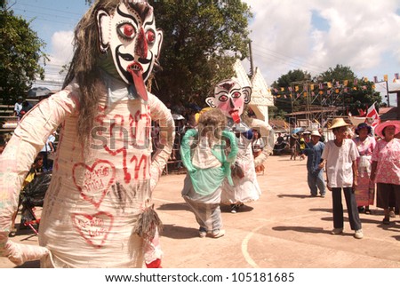 LOEI, THAILAND - JULY 1:  People dress in spirit and wear a big mask, show sing and dance is traditional cullture in Ghost mask festival (Phi Ta Khon Festival) on July 1,2011 in Loei, Thailand.