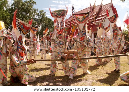 LOEI, THAILAND - JULY 1:  People dress in spirit and wear a  mask, show sing and dance is traditional culture in Ghost mask festival (Phi Ta Khon Festival) on July 1,2011 in Loei, Thailand.