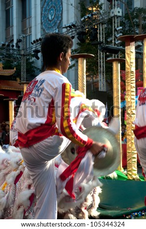 BANGKOK--JANUARY 20: Unidentified performer provide music for the traditional Lion Dance outside the Temple during Chinese New Year celebrations on January 20, 2012 in Bangkok,Thailand.