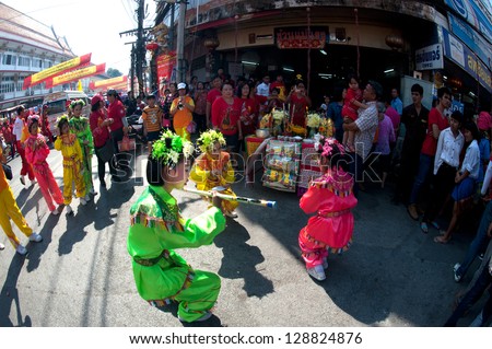 NAKHONSAWAN, THAILAND-: FEB 13 : Unidentified young girls Chinese Fairy of gods doing ritual at worship table of people in Chinese New Year Celebrations on February 13, 2013 in Nakhonsawan , Thailand.