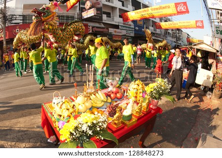NAKHONSAWAN/ THAILAND-FEBRUARY 13 : Golden dragon doing ritual at worship table of people in Chinese New Year Celebrations on February 13, 2013 in Nakhonsawan Province,Middle of Thailand.