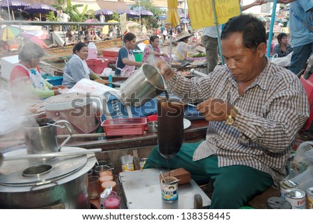 SAMUTSONGKRAM,THAILAND-SEPT 6 : Men working coffee on his boat in Amphawa evening floating Market famous floating market and cultural tourist destination on Sept  6, 2012 in Samutsongkram, Thailand.