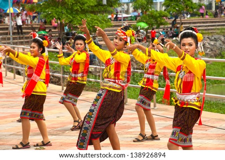 YASOTHON,THAILAND - MAY 12 : Unidentified woman traditional dancing on parades in Rocket festival. The celebration for plentiful rains during the rice plant season,on May12,2013 in Yasothon,Thailand.