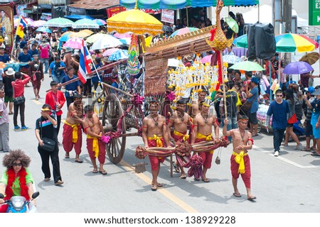 YASOTHON,THAILAND-MAY 11: Ancient rocket with cart on parades showing in Rocket festival. The celebration for plentiful rains during the rice plant season,on May11,2013 in Yasothon,Thailand.