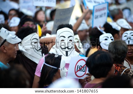 BANGKOK,THAILAND-JUNE 9 : Unidentified demonstrators from the ant i- government  V for Thailand group wearing  Guy Fawkes masks attend rally outside a shopping mall on June 9,2013 in Bangkok,Thailand.