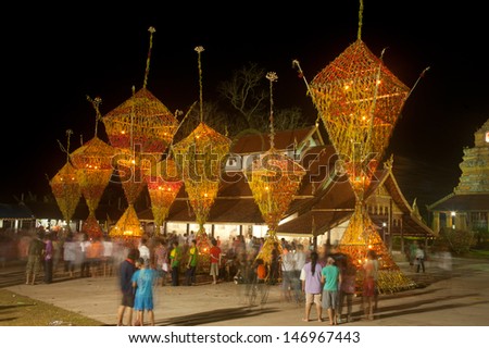 LOEI,THAILAND- APRIL 14 : Thai villagers carrying the flower parade in worship around the Church with joy and fun at Wat Sri  Pho Chai temple on April 14,2013 in ,Loei Province,Northeast of Thailand.