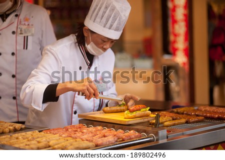 LIJIANG,CHINA Ã¢Â?Â? MARCH 17 : The daily lives of Naxi people in new food store open for tourists in Historical Dayan old town on March 17, 2014 in  Lijiang city,Yunnan province,Southwestern of China..