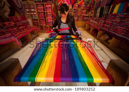 LIJIANG,CHINA Ã¢Â?Â? MARCH 17: Naxi women weaving brightly colored Show of visitors and sales wholehearted in Lijiang is the largest ancient old town on March 17, 2014, Yunnan in Southwestern of China.