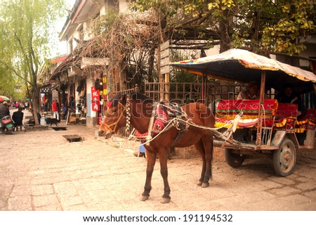 LIJIANG,CHINA - MARCH 16 : Carriage waiting at Shuhe ancient town for tourists service on March 16,2014.Shuhe is the ancient old town in Lijiang city , Yunnan province in Southwestern of China.