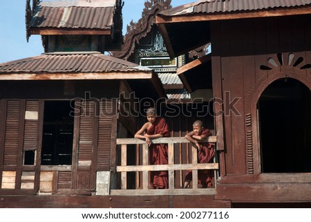 INLE,MYANMAR-FEBRUARY 4 : Young Novice monks standing at wooden Church of Nyan Shwe Kgua temple near Inle lake on February 4,2013 in Inle lake,Shan State,Middle of Myanmar.