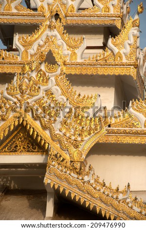 MANDALAY,MYANMAR-JUNE 29: Full front view of Myanmar wood art on Pagoda roof in Mahamyatmuni Buddha temple on June 29,2014 in Mandalay city,Middle of Myanmar.