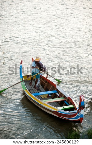 AMARAPURA,MYANMAR-JUN 30: Unidentified local citizens paddle wooden boat on Taungthaman lake near U-Bein Bridge is believed to be the oldest teak bridge in the World on June 30,2014,Amarapura,Myanmar.
