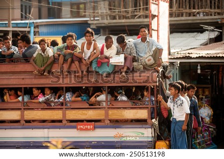 MANDALAY,MYANMAR - JULY 2 : unidentified Burmese peoples in a truck on July 2, 2014 in Mandalay city, Middle of Myanmar. Truck is a popular transportation in Myanmar because it can carry many people.
