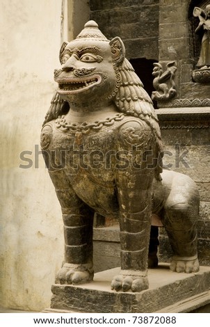 Statue of mythical beast guarding the entrance to the temple in the Patan Durbar Square,  Nepal.