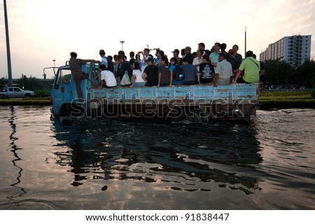 BANGKOK, THAILAND-NOVEMBER 11: Transportation of people in the streets flooded after the heaviest monsoon rain in 50 years in the capital on November 11, 2011 Phahon Yothin Road, bangkok, Thailand.