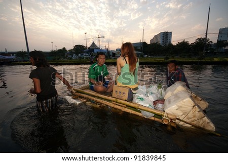 BANGKOK, THAILAND-NOVEMBER 11: Transportation of people in the streets flooded after the heaviest monsoon rain in 50 years in the capital on November 11, 2011 Phahon Yothin Road, bangkok,
