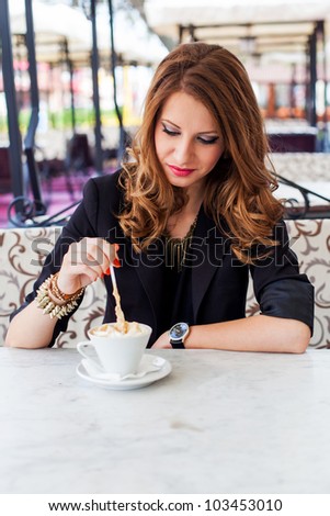 Beautiful girl drinking coffee outside