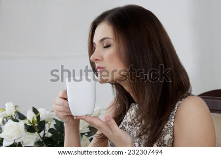 Brunette girl. coffee drinking tea. smile sexy