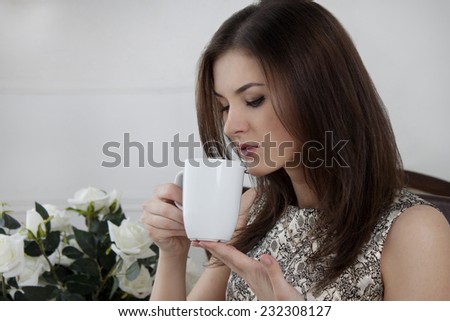 Brunette girl. coffee drinking tea. smile sexy