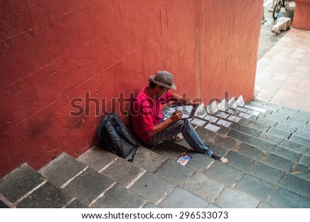 MELAKA, MALAYSIA - APRIL 15: Unidentified man draw the picture on the street. The picture draw about interesting place of Melaka or urban art in Melaka, Malaysia on April 15, 2013