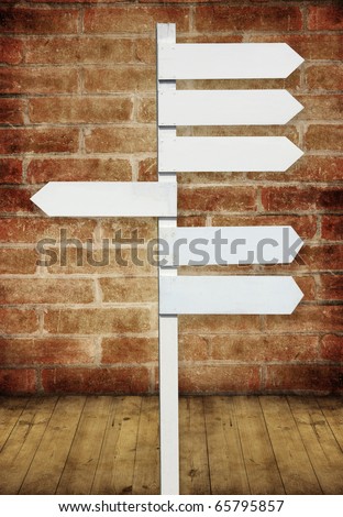 blank direction sign on brick wall room