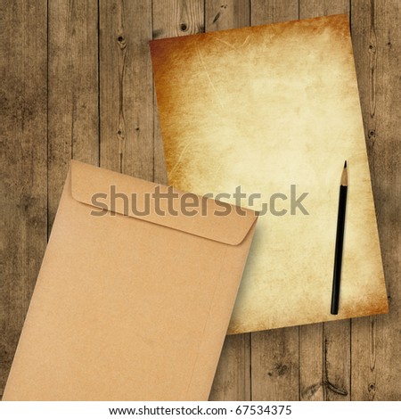 grunge paper with envelope on the wooden background