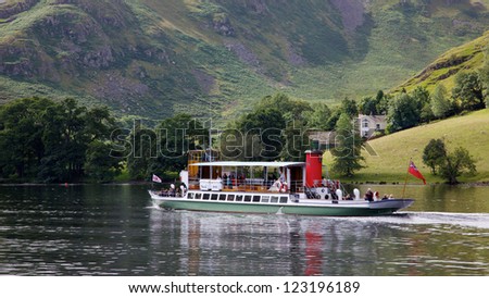 ULLSWATER, ENGLAND - JULY 31: Tourists aboard the \'Raven\' in the English Lake District, on July 31, 2012. Ullswater Steamers have been sailing on the lake since 1859; the Raven was launched in 1889.
