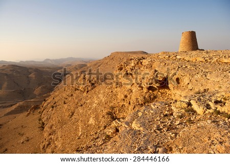 One of the Beehive Tombs of Bat, perched dramatically atop a rocky ridge in Oman. The tombs are a Unesco World Heritage Site.