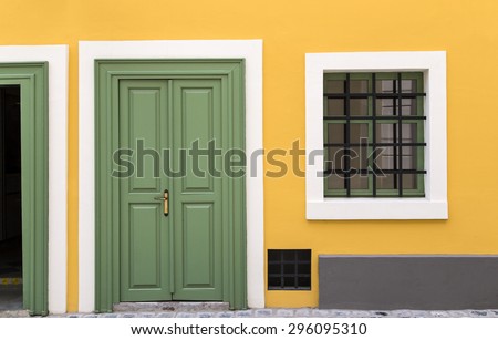 Details of a yellow house with green door and window