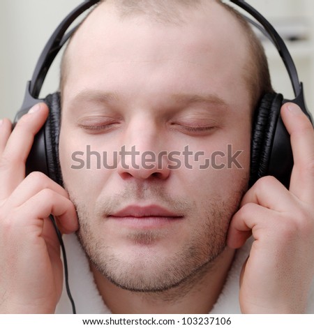 young men  listen music in headphones