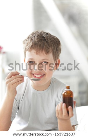 happy boy drinking cough syrup