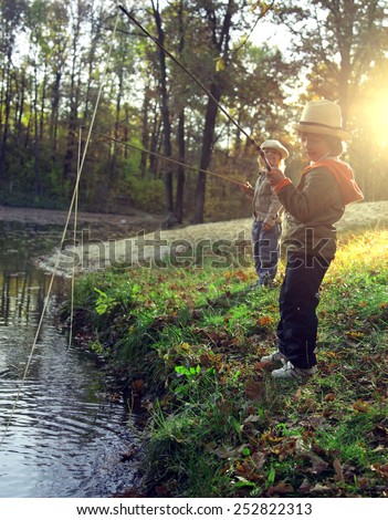 happy boys go fishing on the river, photo with artistic lens flare