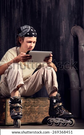 teenager sitting on box with tablet pc