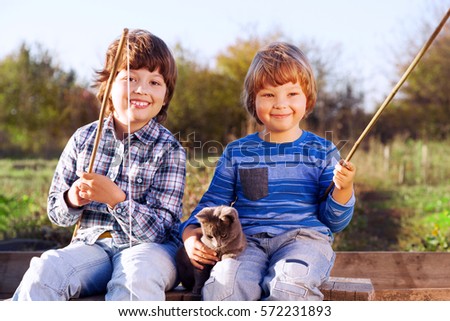 Similar – Image, Stock Photo Children playing with fishing rod toy in a pool in a home garden