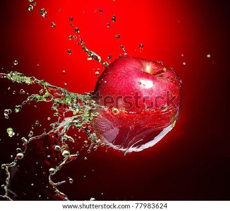 red apple in juice stream