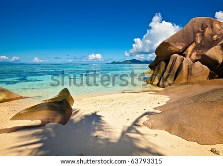 Dream seascape view with a big stones and palm tree, Seychelles, La Digue island