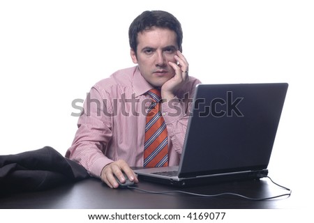 The businessman in a suit behind a table, with portable PC...