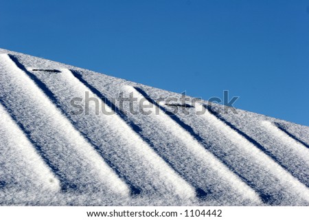 roof  with  snow  in  winter in the  sun
