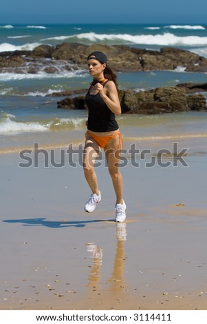 Athletic model running fast on the beach