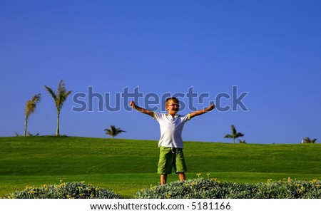 boy with his arms wide open on a golf camp