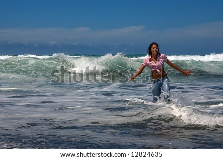 sexy young woman with jeans in the beach under blue sky