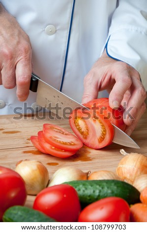 Preparing food: cutting a fresh tomato