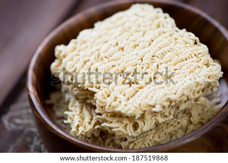Close-up of dry chinese noodles in a wooden bowl