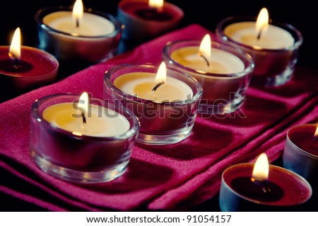 Close-up of burning votive candles