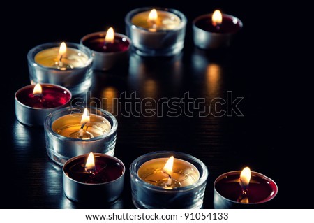 Still life series: burning tea light candles in a semicircle