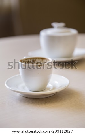 Coffee cup in natural light on wooden table