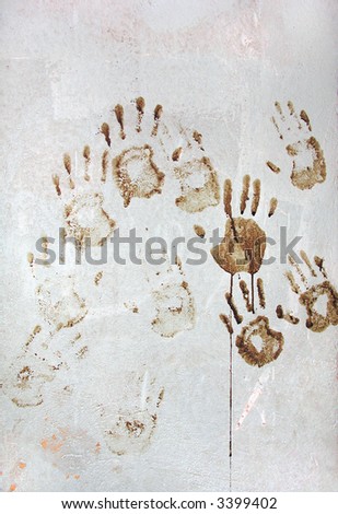 Hand prints with blood on concrete wall