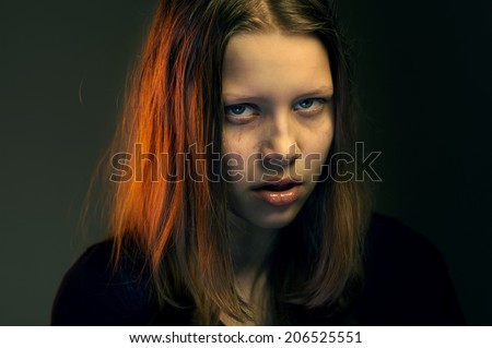 Angry crazy teen girl looking with hatred in her eyes
