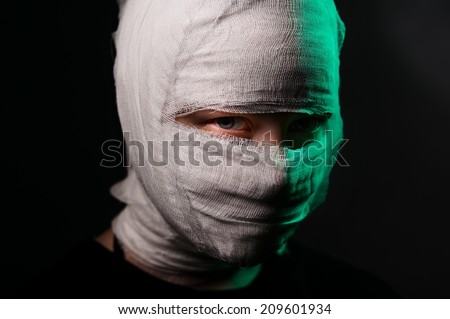 Dark portrait of an infected sick girl with a bandage on her head