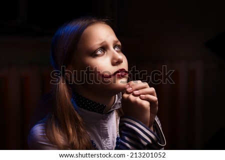 Sad clown teen girl praying